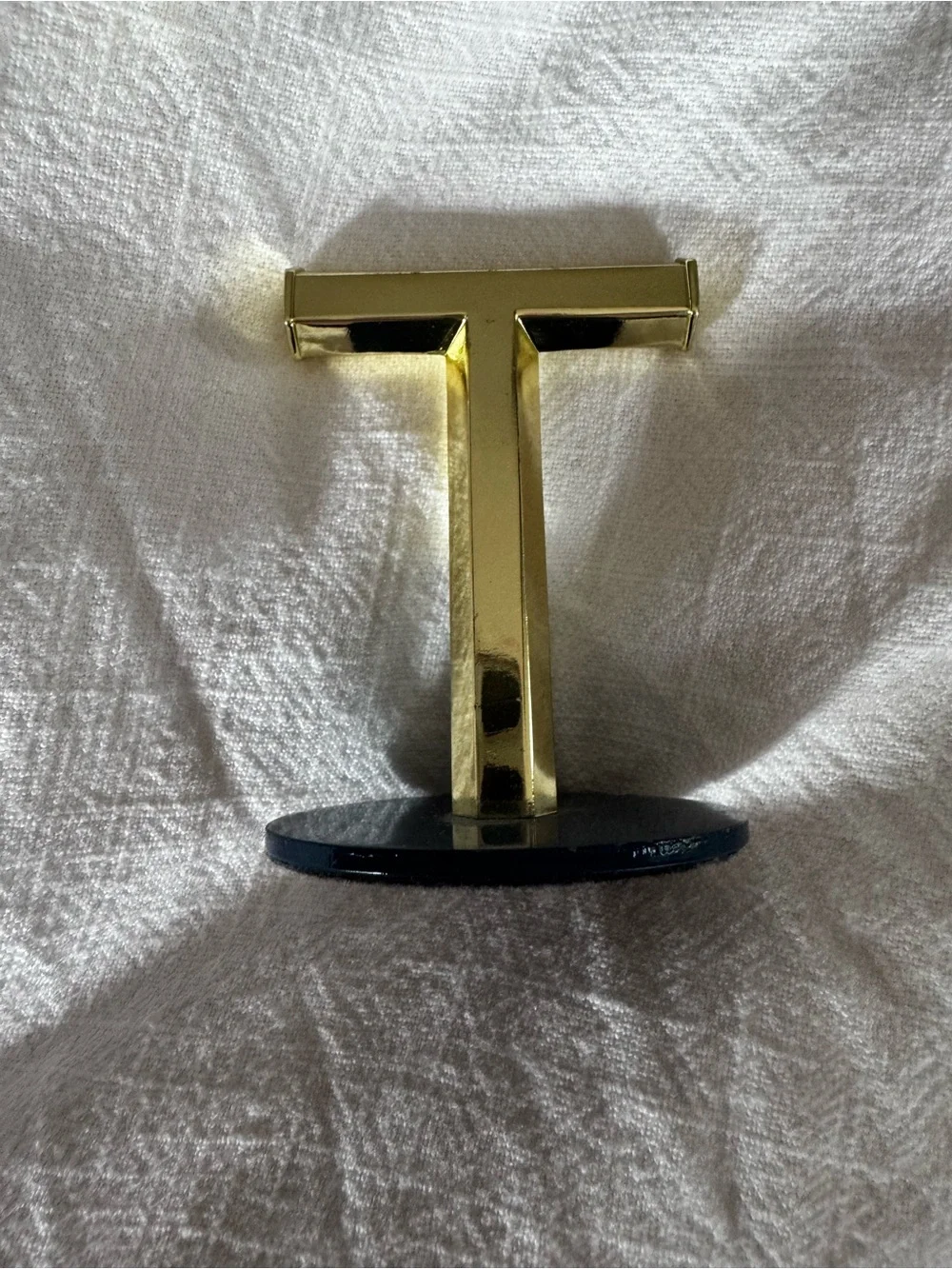 Umbra Gold T-Shaped Jewelry Stand on Navy Base